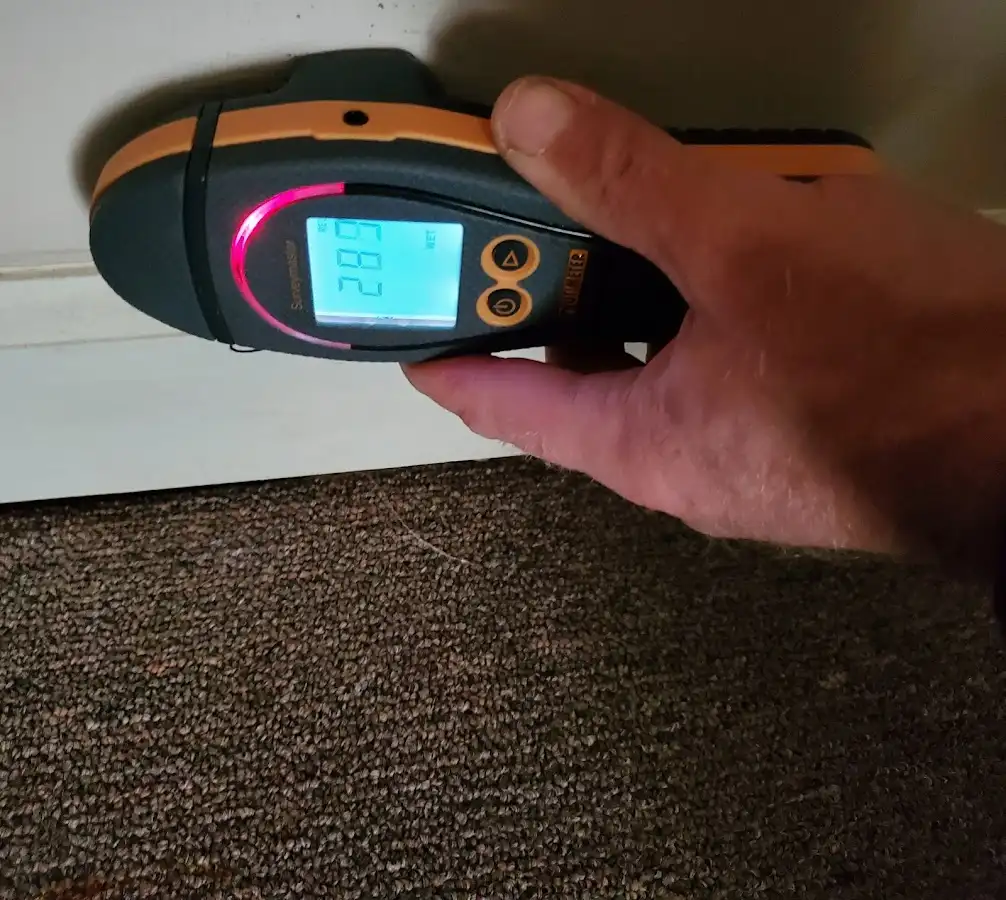Moisture detection at baseboard during Storm Damage Restoration in Farmingdale